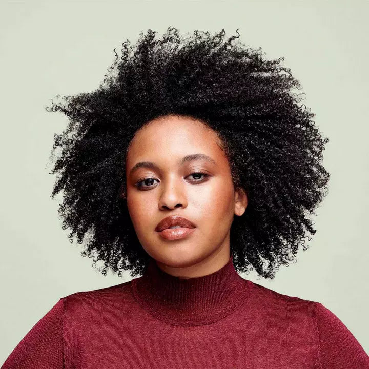 Model before and after use of Deva Curl One Condition Decadence - Ultra-Rich Cream Conditioner 