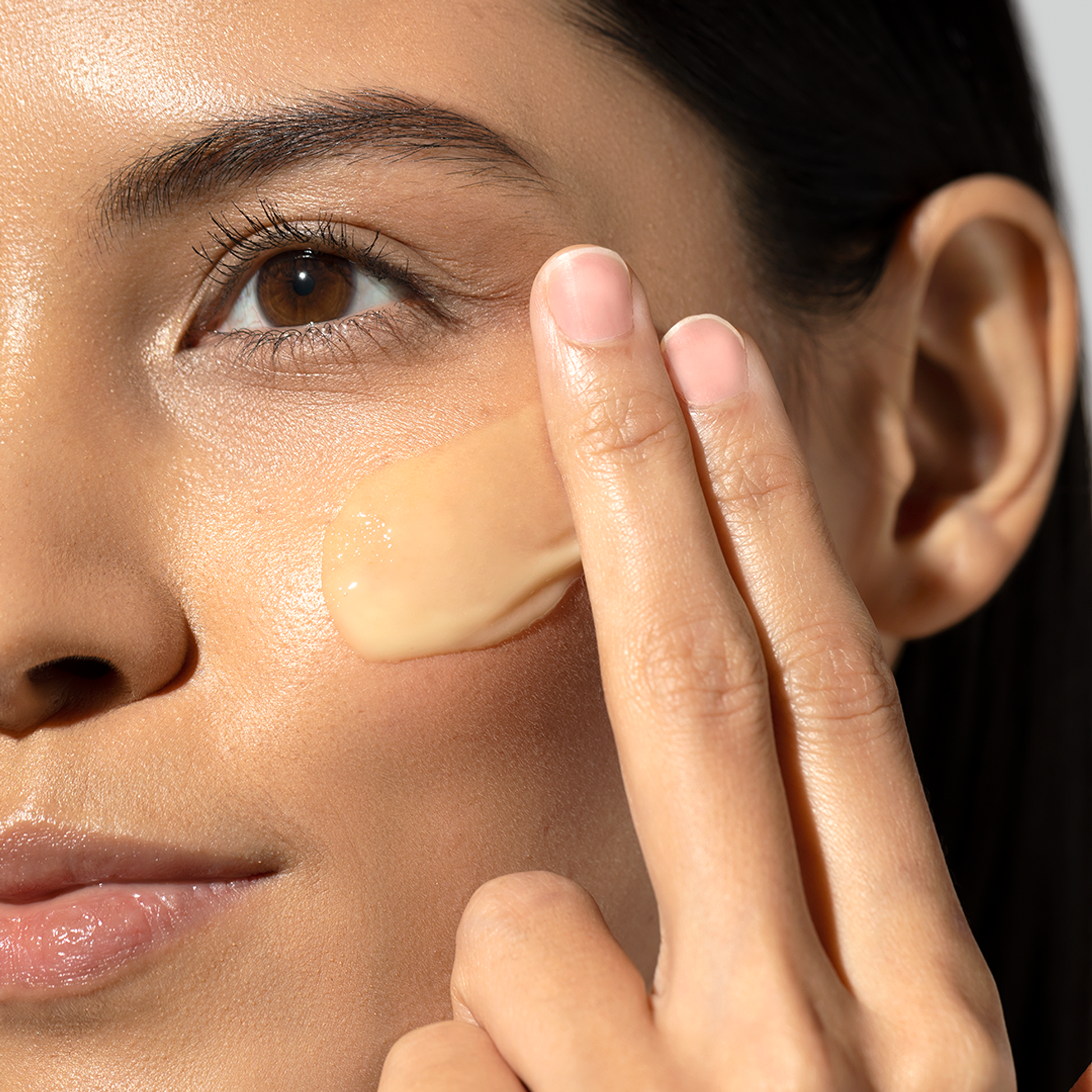 Model applying Dermalogica Biolumin-C Gel Moisturizer to face